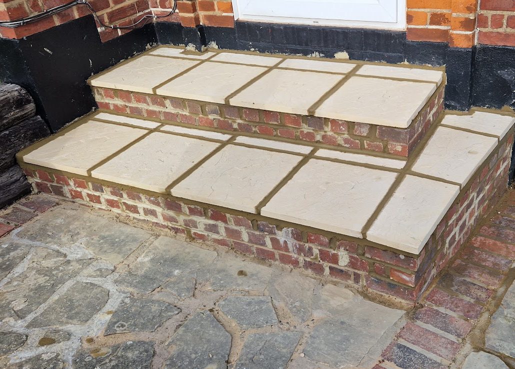 Two brick steps with buff stone treads